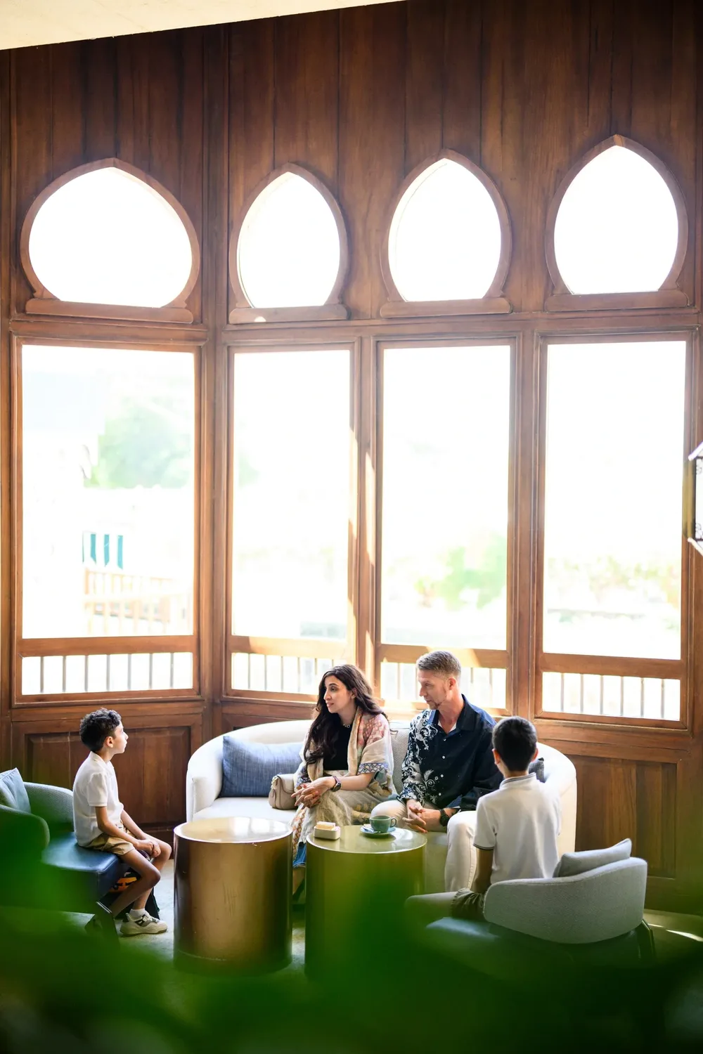 Family relaxing in a hotel lounge during a corporate travel package